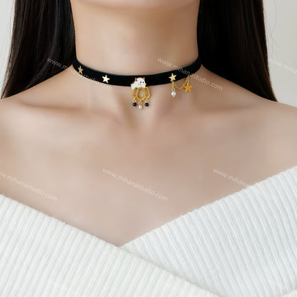 Black choker necklace with gold accents worn by a person against a white background