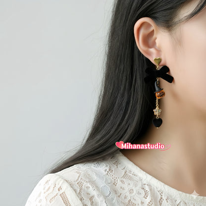 Earring worn by a person with a plain background, featuring the brand 'Mihanastudio'.