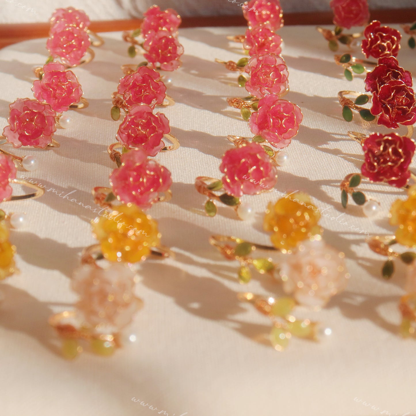 Colorful floral earrings on a light background