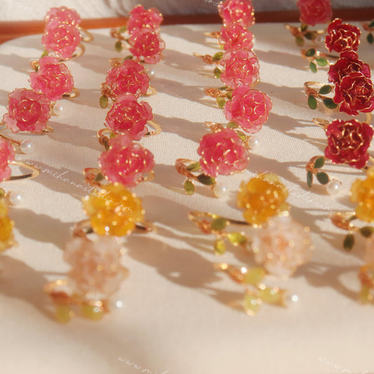 Colorful floral earrings on a light background