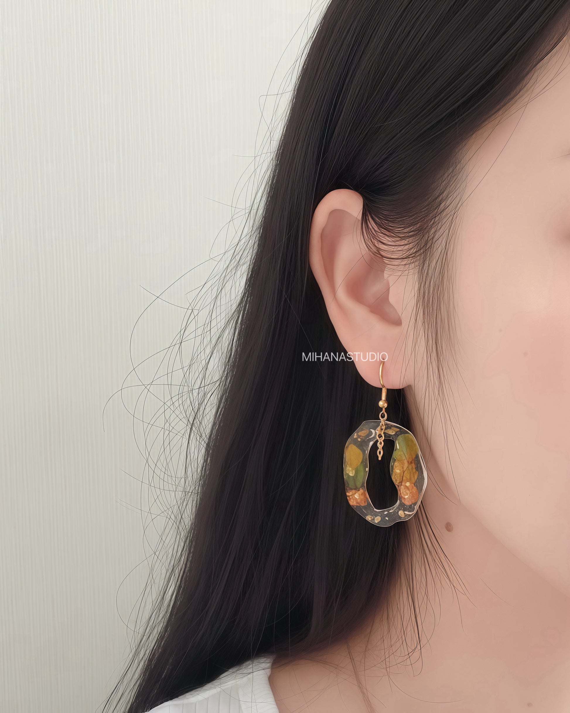 Earring worn by a person with a neutral background