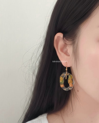 Earring worn by a person with a neutral background