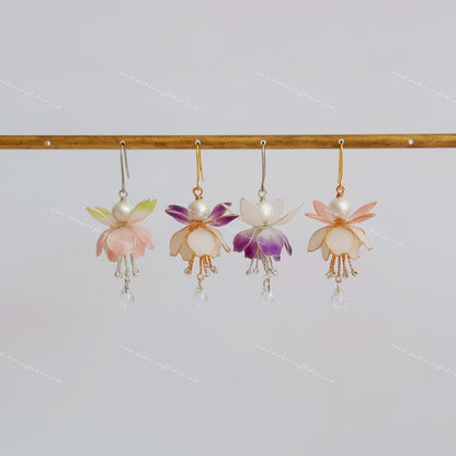 Fuchsia flower earrings hanging in four colourways