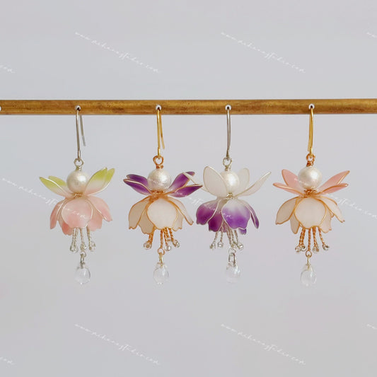 Fuchsia flower earrings hanging in four colourways